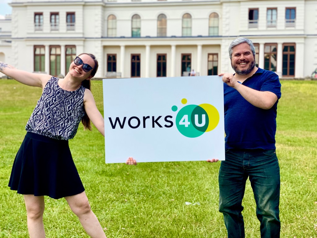 Works4U Dominic Pinkney and Martyna Bielecka holding Works4U sign